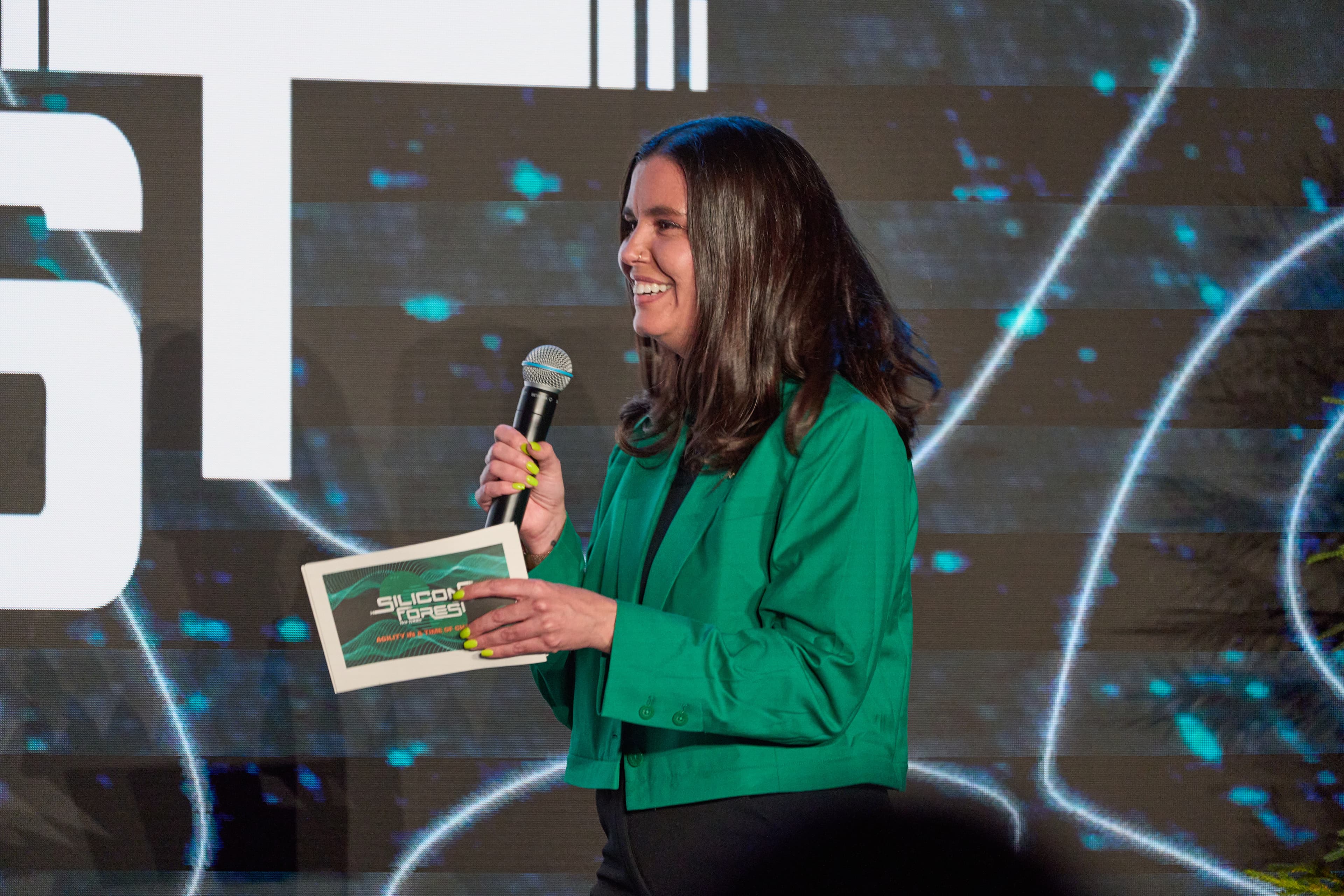 An AI Portland co-founder speaking into a microphone at the Silicon Forest Summit